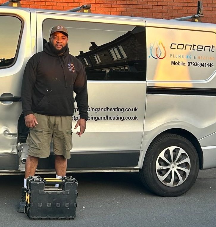 Daniel Sheriffe of Content Plumbing and Heating standing beside his liveried work van