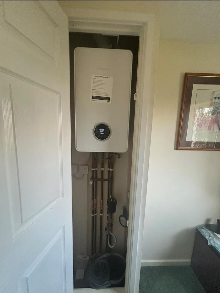 The finished Worcester Bosch boiler installed and commissioned in a hallway cupboard