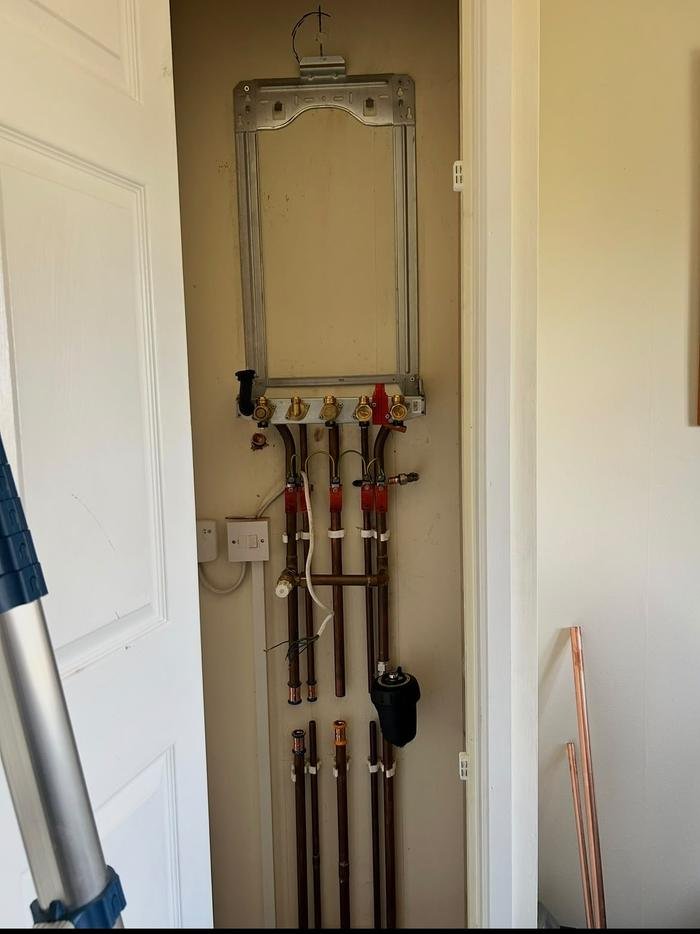 First fix for a Worcester Bosch boiler: mounting frame, valves and new copper pipework set into a cupboard